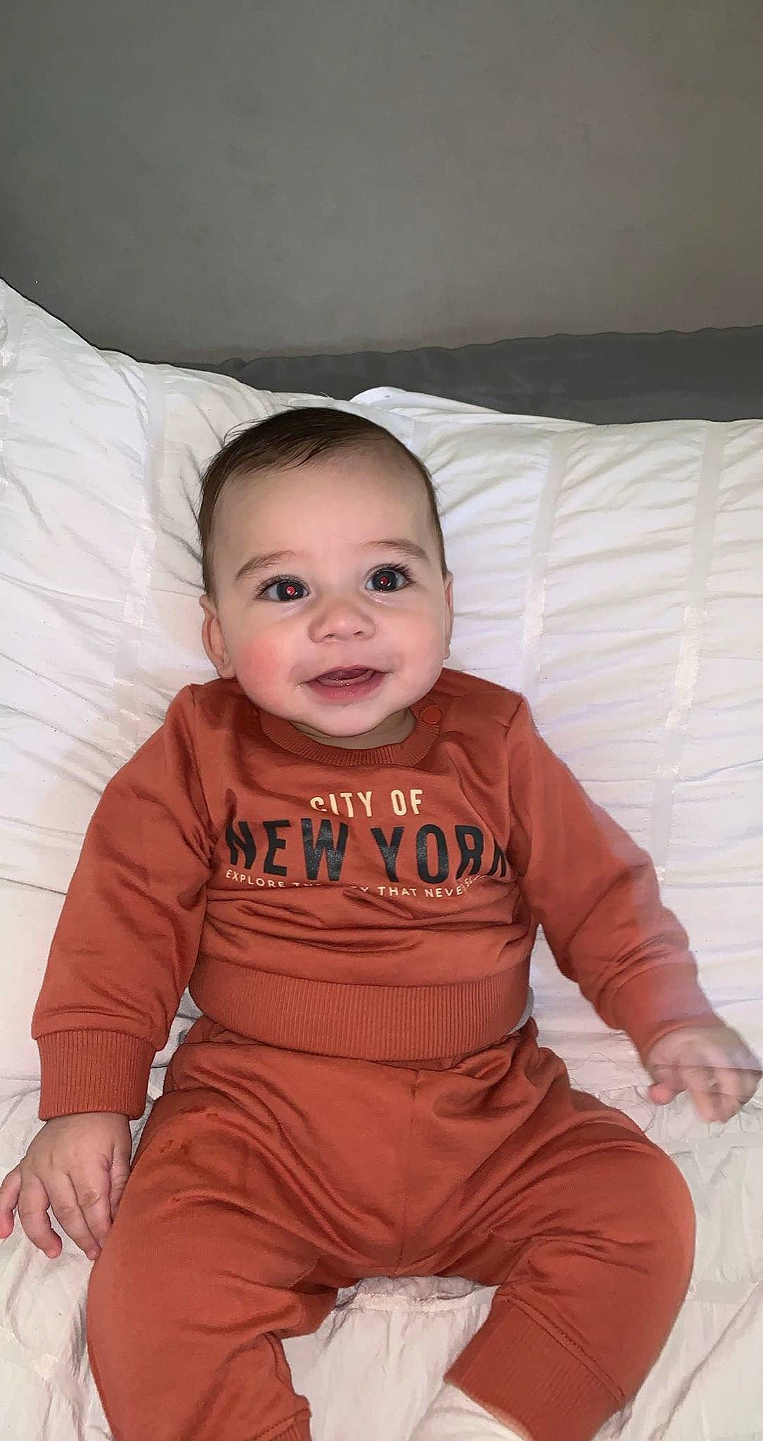 Abram joined the competition — help win amazing prizes! baby, baby_toddler_clothing, cheek, child, chin, comfort, flooring, hair, happy, iris, linens, mouth, nose, person, pillow, sitting, skin, sleeve, smile, t_shirt