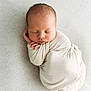 Colter joined the competition — help win amazing prizes! newborn, baby, swaddled, sleeping, infant, peaceful, soft, blanket, cream, closeup, portrait, cute, tiny_hands, resting, delicate, cozy, child, indoors, texture, calm
