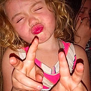 Elizabeth is registered to the contest to win money with this photo: child, girl, curly_hair, pink_lips, peace_sign, hand_gesture, playful, smiling, colorful_dress, indoor, portrait, two_children, fun, happy, expression, casual, flash_photo, closeup, person, cute