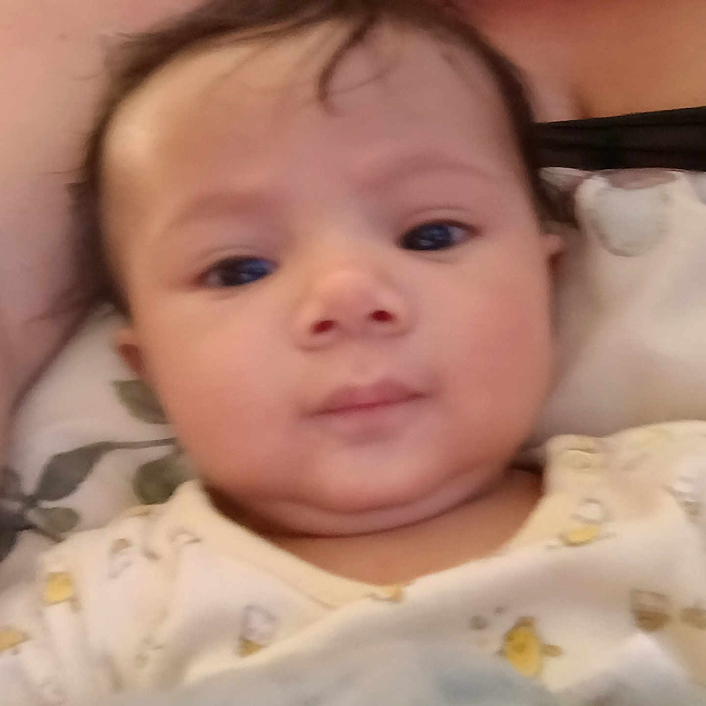 Nunliah is registered to the contest to win money with this photo: baby, blanket, child, closeup, clothing, comfort, cute, expression, eyes, face, hair, head, indoors, infant, mouth, person, portrait, skin, soft, young