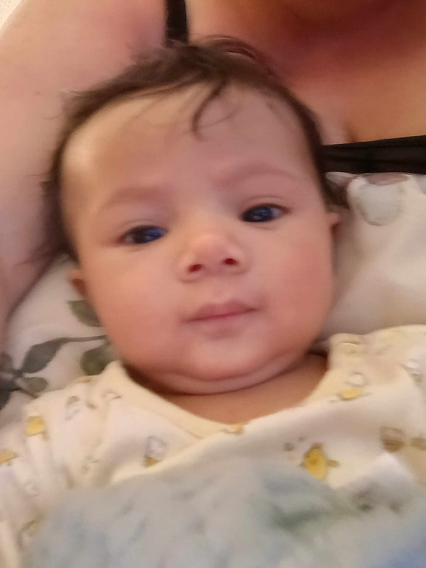 Nunliah is registered to the contest to win money with this photo: baby, blanket, child, closeup, clothing, comfort, cute, expression, eyes, face, hair, head, indoors, infant, mouth, person, portrait, skin, soft, young