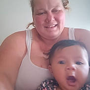 Nunliah is registered to the contest to win money with this photo: adult, baby, casual, child, closeup, clothing, expression, face, family, floral_pattern, hair, head, indoor, moment, person, portrait, skin, smile, surprised, tank_top