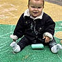 toddler, child, smiling, jacket, chalk, playground, outdoor, sitting, sock, happy, face, person, toy, ground, colorful, casual_clothing, cute, young_child, play, daytime