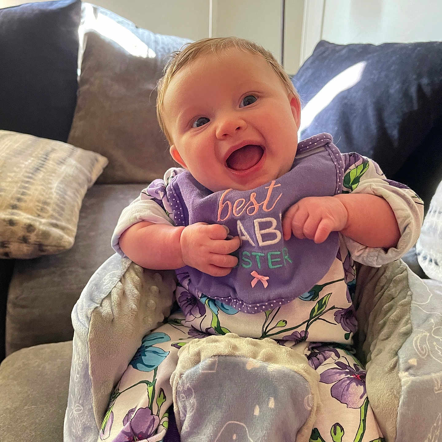 Madelynn joined the competition — help win amazing prizes! architecture, baby, babylaughing, building, couch, cushion, face, furniture, happy, head, homedecor, indoors, laughing, livingroom, person, photography, pillow, portrait, room, sitting