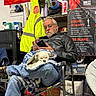 Chipp joined the competition — help win amazing prizes! man, dog, blanket, chair, leather_jacket, glasses, phone, sitting, shelf, storage, jacket, poster, box, indoor, casual, relaxed, pet, white_dog, jeans, footwear