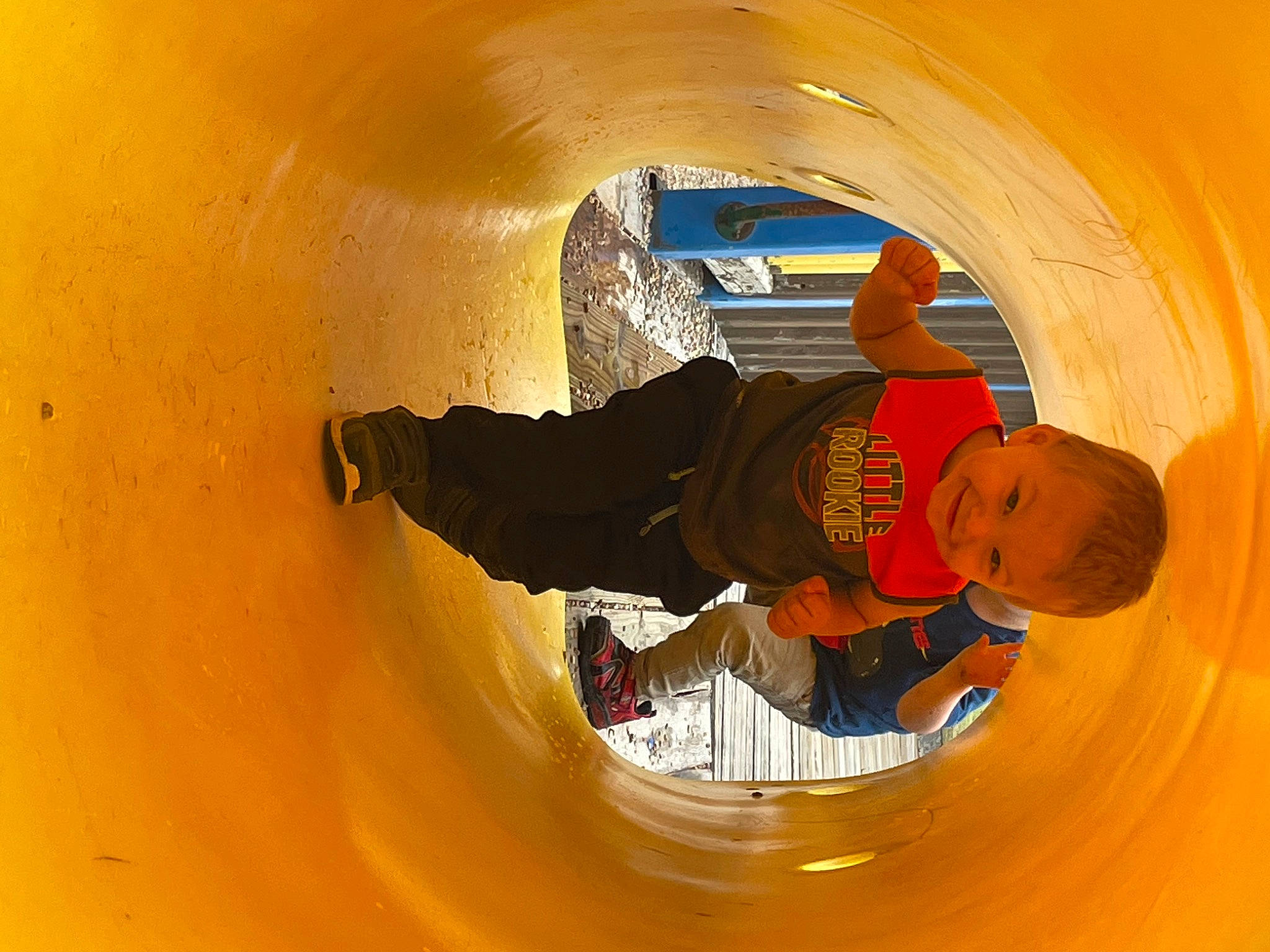 Braxton is registered to the contest to win money with this photo: amber, ceiling, circle, concrete, fun, hat, joy, leisure, orange, person, personal_protective_equipment, recreation, sleeve, space, t_shirt, tints_and_shades, toddler, walking_shoe, window