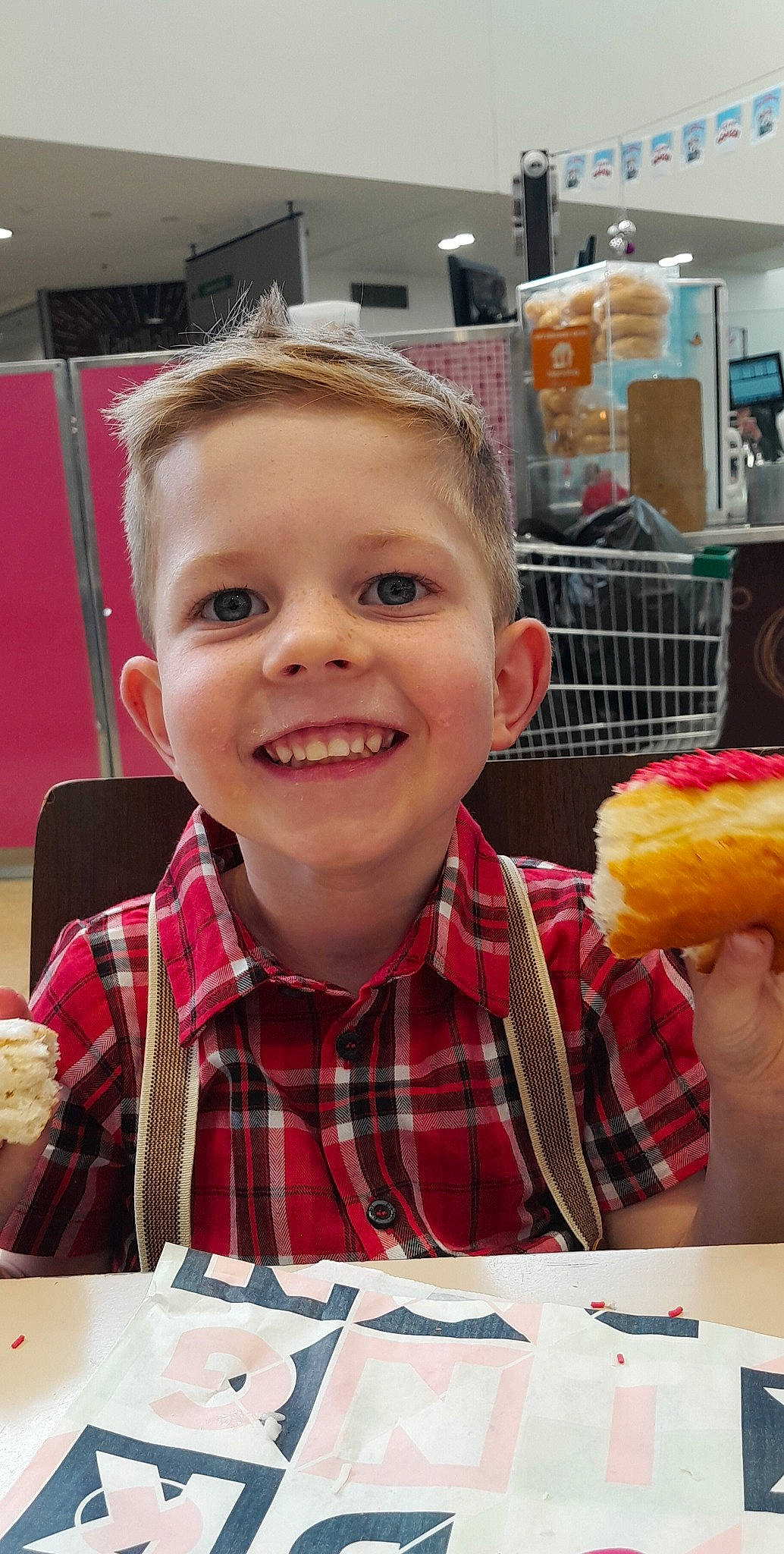 Casey is registered to the contest to win money with this photo: carmine, child, event, fast_food, food, fried_food, fun, happy, joy, junk_food, party, pattern, person, plaid, recreation, smile, snapshot, sweetness, table, tartan