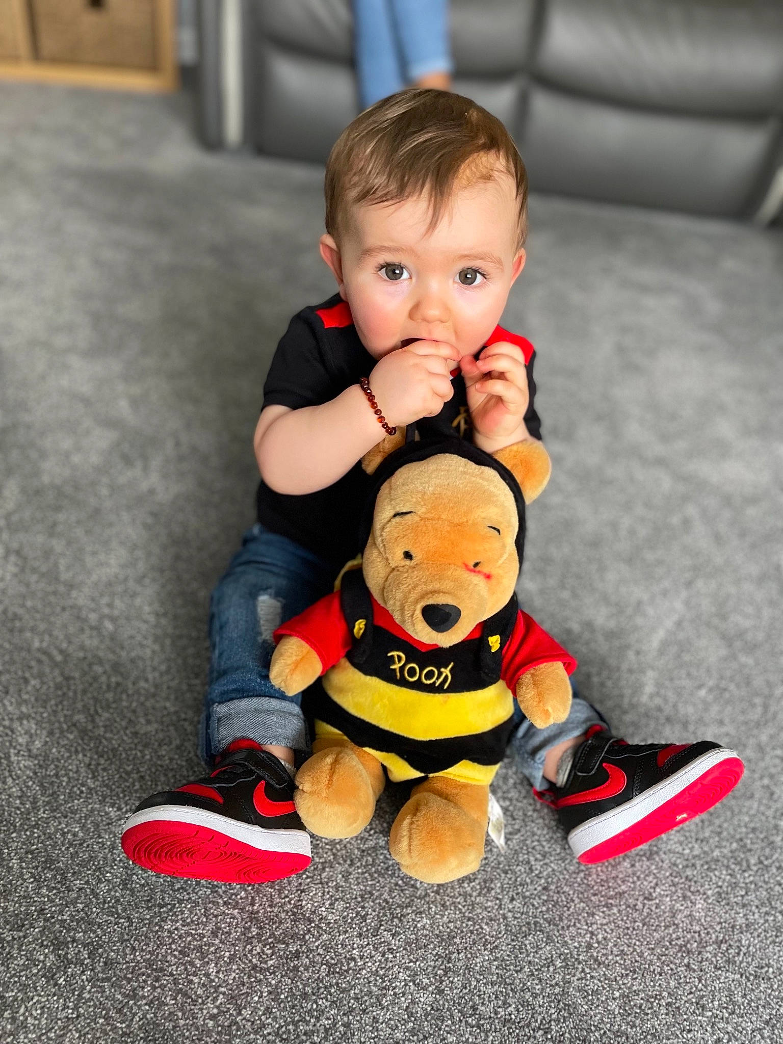 Koby is registered to the contest to win money with this photo: baby, baby_toddler_clothing, child, face, finger, floor, flooring, footwear, fun, happy, head, leg, orange, person, shoe, skin, sneakers, sock, surprise, toddler