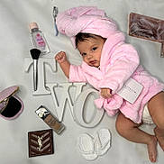 Aalayah joined the competition — help win amazing prizes! baby, pink_robe, towel_turban, makeup_brush, foundation, compact_mirror, lipstick, baby_booties, decorative_letters, face, infant, cosmetics, skincare, lying_down, cute, portrait, beauty, child, soft_texture, indoor