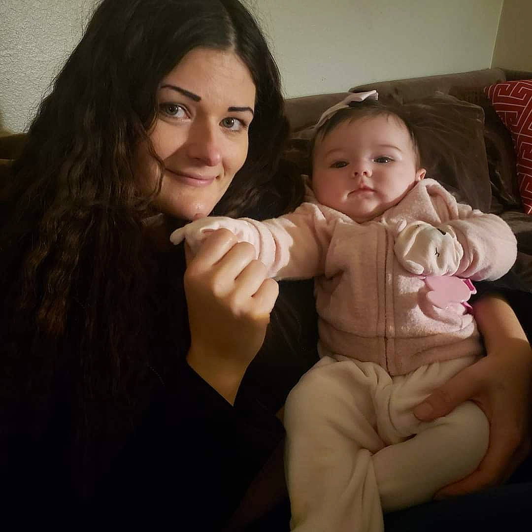 Stormy is registered to the contest to win money with this photo: arm, baby, cheek, child, eye, face, finger, fun, gesture, hand, head, iris, joy, long_hair, nose, people, person, sitting, skin, smile