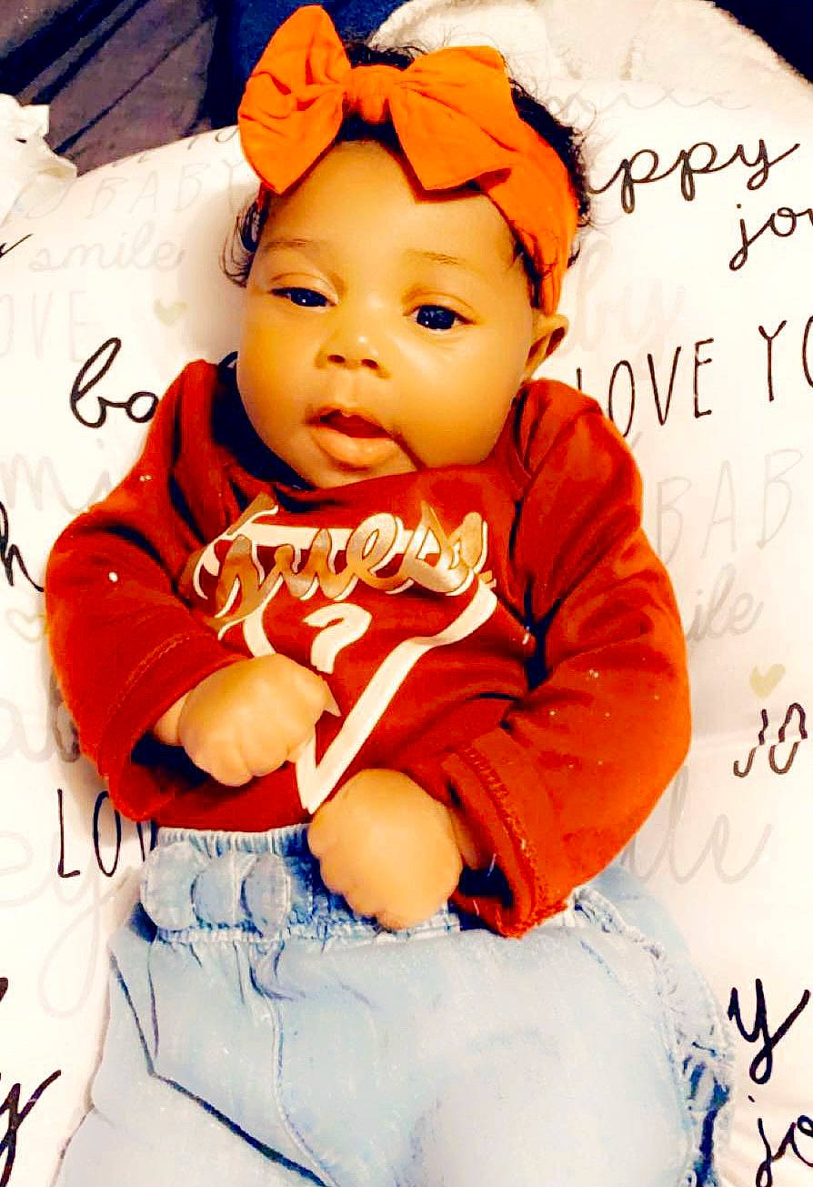 Jai Lynn joined the competition — help win amazing prizes! baby, baby_toddler_clothing, cheek, child, child_model, costume_accessory, handwriting, headband, headwear, orange, peach, person, photo_shoot, sitting, toddler