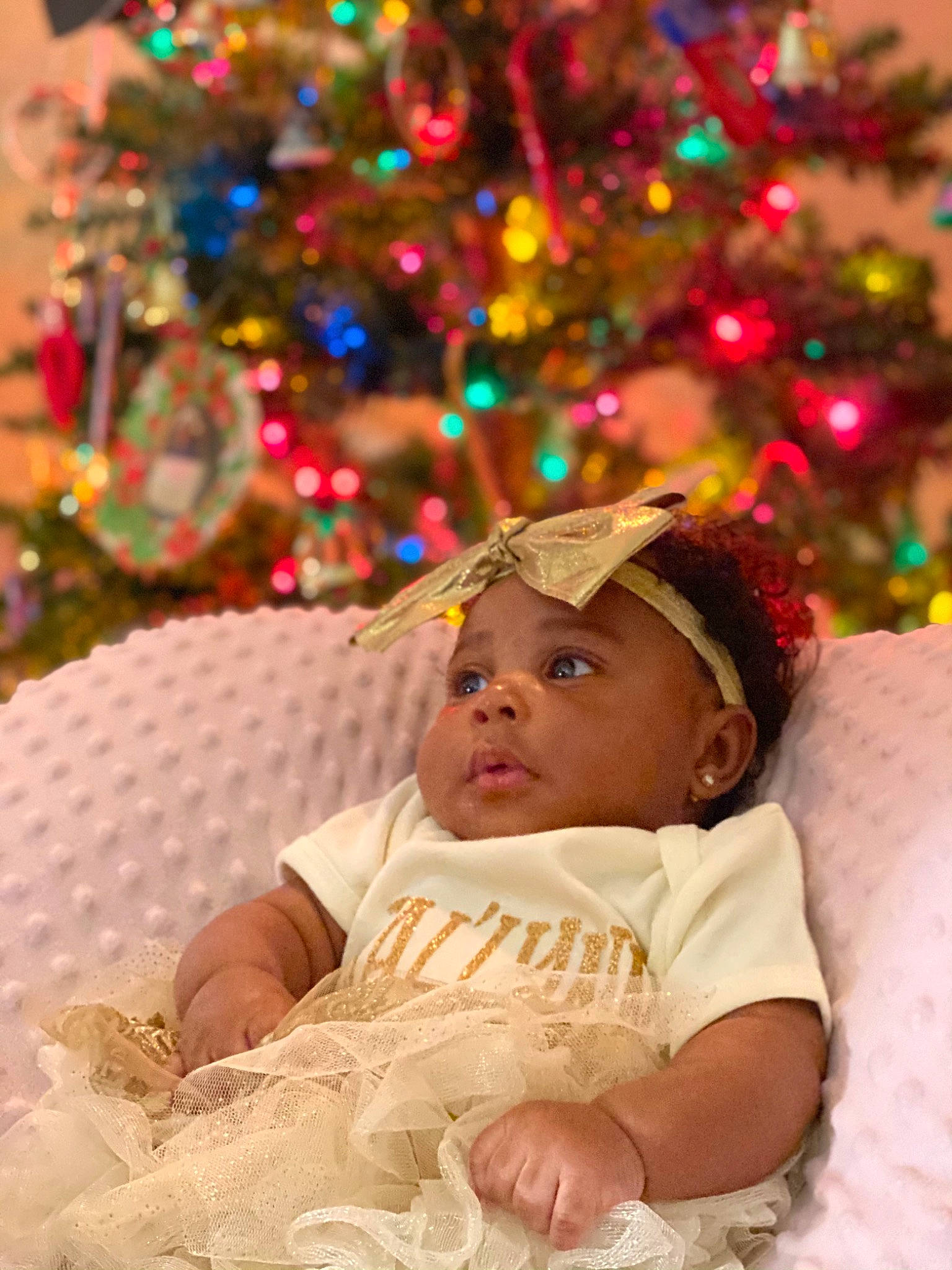 Jai Lynn is registered to the contest to win money with this photo: baby, baby_toddler_clothing, child, christmas, christmas_decoration, christmas_eve, christmas_lights, christmas_ornament, christmas_tree, costume_accessory, event, hair_accessory, holiday, holiday_ornament, human, interior_design, nose, ornament, person, toddler