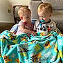 Rylo is registered to the contest to win money with this photo: toddler, child, pacifier, blanket, blue, cartoon, dog, furniture, living_room, carpet, chair, clothing, cute, infant, sitting, indoors, person, young_child, comfort, family
