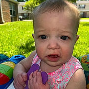 Rilynn joined the competition — help win amazing prizes! baby, child, outdoor, grass, toy, holding, pink_clothing, curious, face, expression, summer, sunlight, blurred_background, house, play, infant, person, closeup, skin, hands