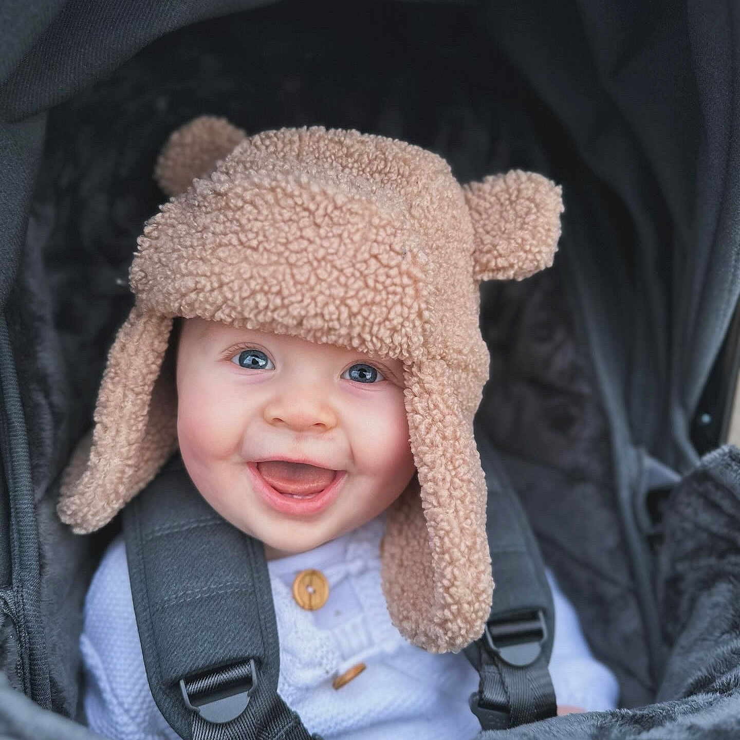 Jude is registered to the contest to win money with this photo: baby, babylaughing, clothing, coat, face, happy, hat, head, hood, jacket, laughing, person, photography, portrait, smile
