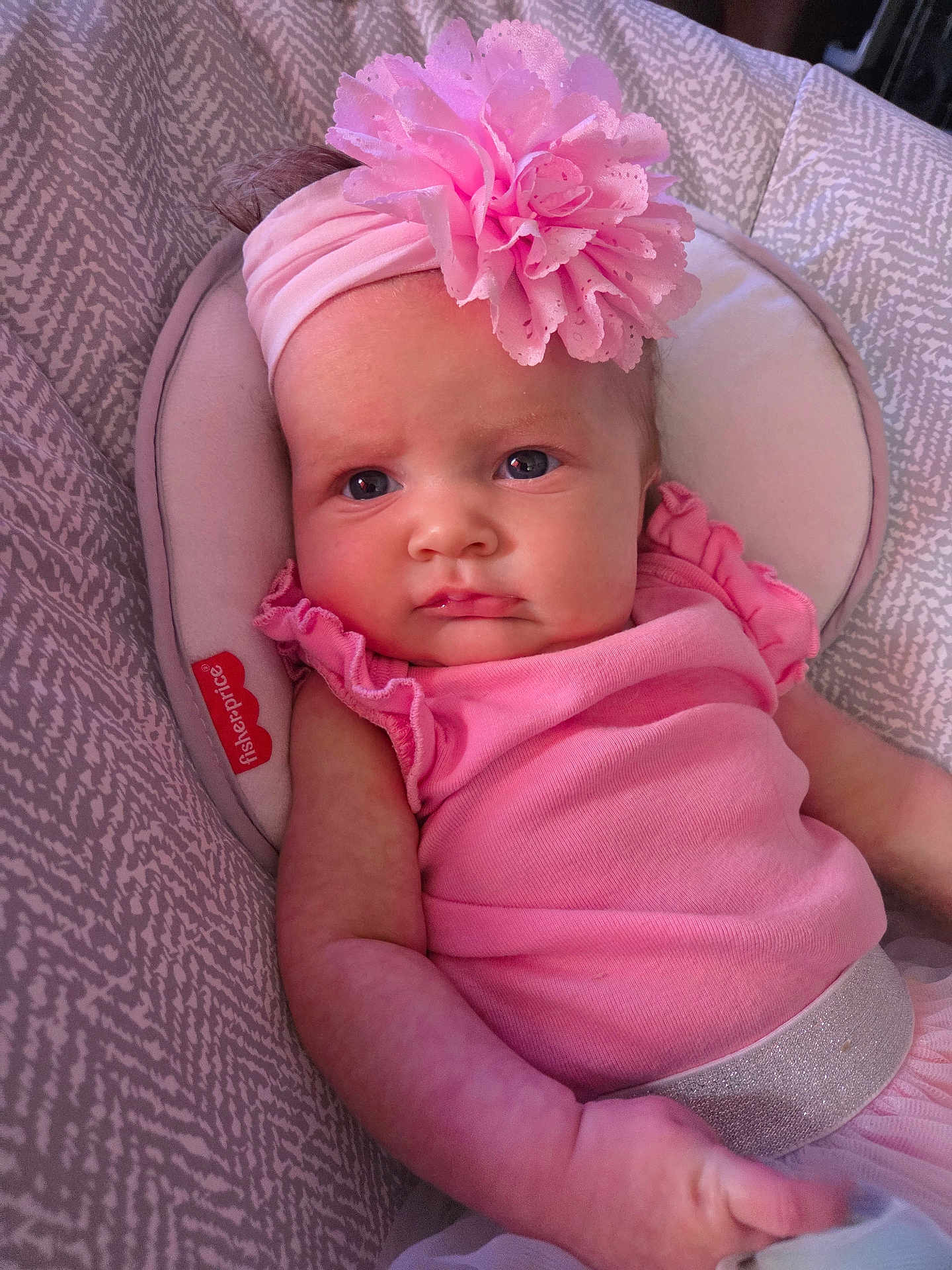 Harper joined the competition — help win amazing prizes! baby, infant, pink, headband, flower, clothing, cushion, seat, face, portrait, child, person, cute, expression, indoors, soft, skin, closeup, fashion, accessory