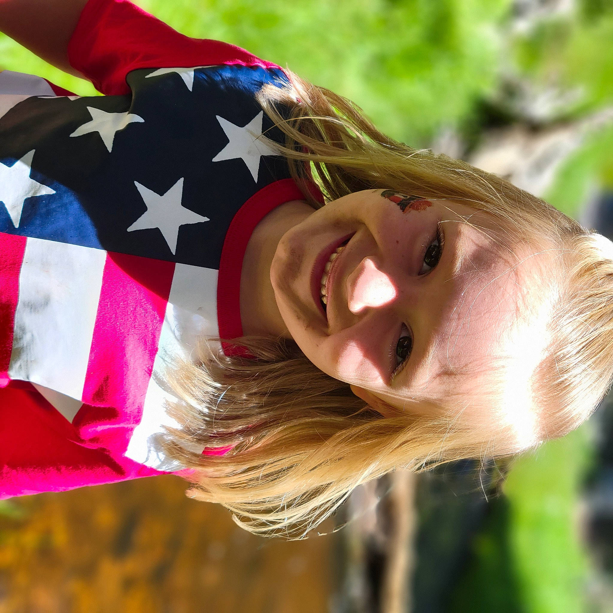 Evelynn joined the competition — help win amazing prizes! brown_hair, child, fashion_accessory, feathered_hair, flag, flag_of_the_united_states, fun, grass, hair_coloring, happy, joy, leisure, lip, magenta, people_in_nature, person, portrait_photography, smile, toddler, water