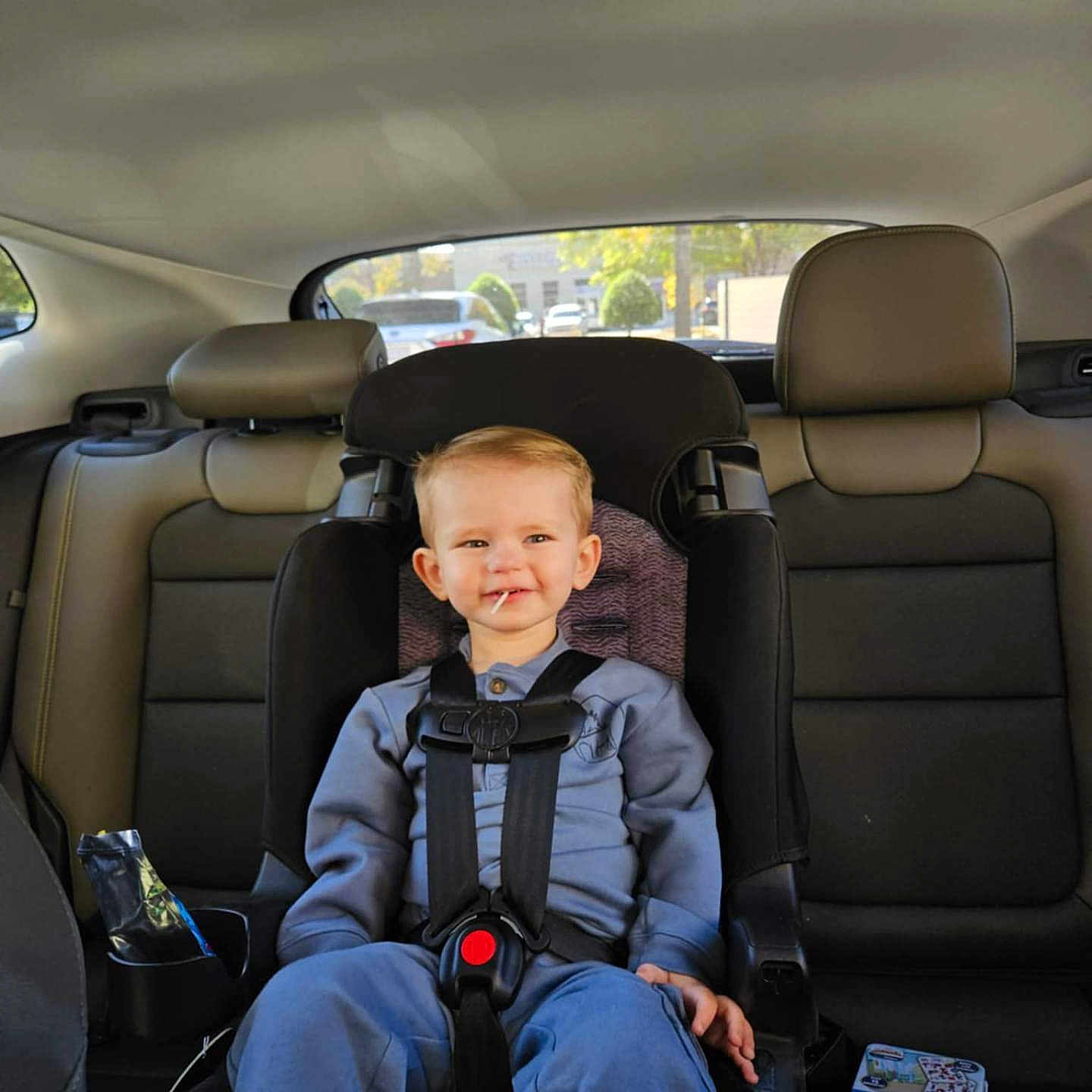 Ezra joined the competition — help win amazing prizes! accessories, belt, boy, car, car_interior, child, clothing, cushion, face, head, homedecor, male, pants, person, photography, portrait, sitting, text, transportation, vehicle