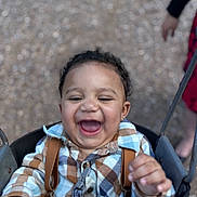 Jamir is registered to the contest to win money with this photo: toddler, child, swing, smiling, laughing, plaid_shirt, suspenders, outdoor, playground, happy, face, person, baby, clothing, joyful, fun, park, cute, young_child, portrait