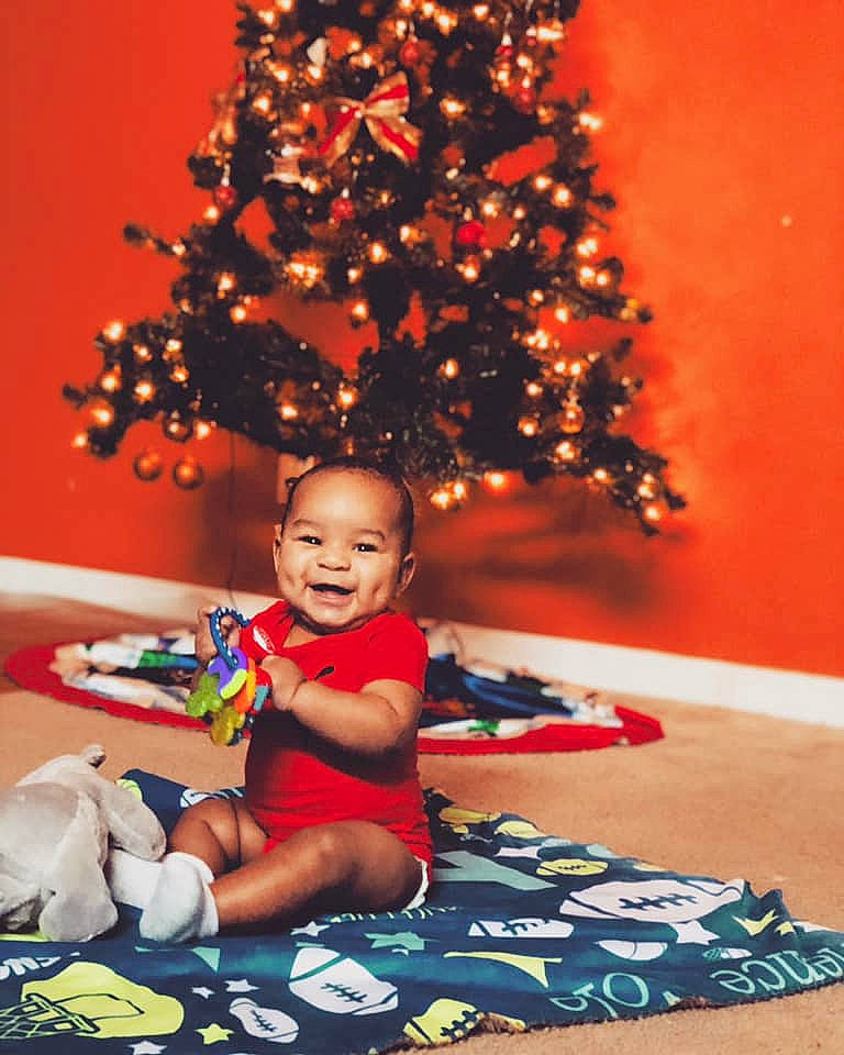 Víence joined the competition — help win amazing prizes! child, christmas, christmas_decoration, christmas_eve, christmas_ornament, christmas_tree, fir, fun, happy, holiday, interior_design, leisure, person, plant, play, red, room, sitting, smile, toddler