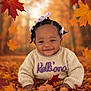 Kelliana is registered to the contest to win money with this photo: baby, child, autumn, fall_leaves, sweater, purple_bows, smiling, outdoor, nature, forest, cute, portrait, seasonal, crawling, happy, young_child, colorful, warm_colors, cozy, playful