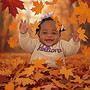 Kelliana is registered to the contest to win money with this photo: baby, child, toddler, autumn, fall_leaves, leaves, smiling, happy, outdoor, nature, seasonal, orange, brown, yellow, sweater, portrait, playful, cute, hair_bows, forest