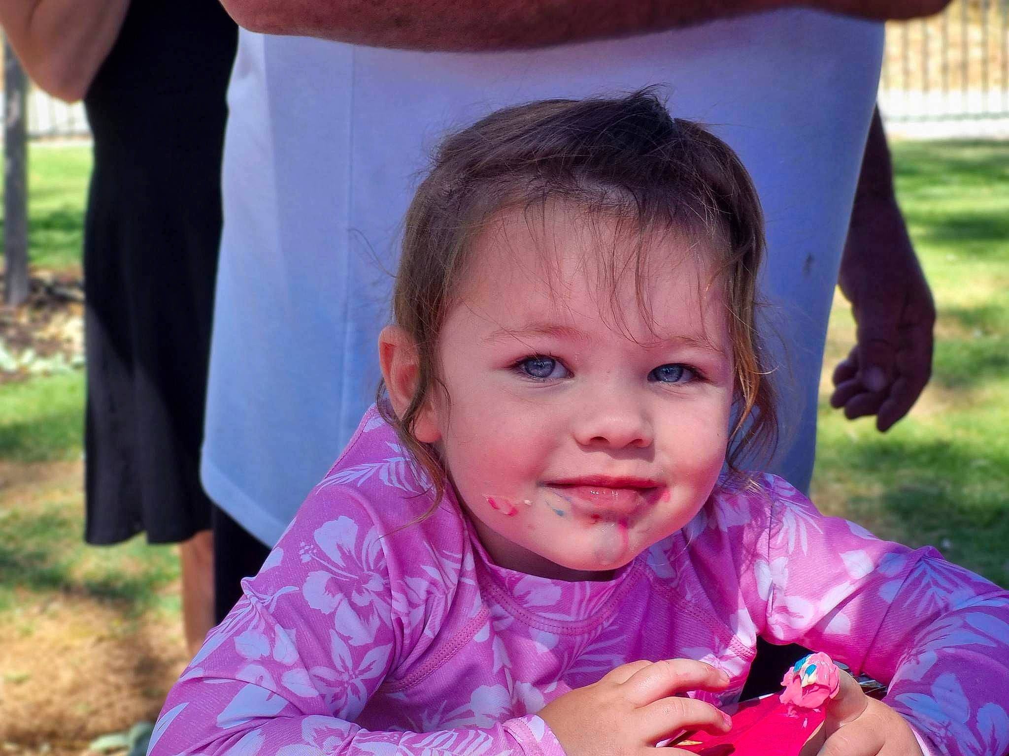 Amilia is registered to the contest to win money with this photo: baby_toddler_clothing, event, eye, facial_expression, finger, fun, grass, happy, iris, joy, leisure, nose, person, photograph, pink, purple, recreation, skin, smile, summer