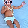 Aisha joined the competition — help win amazing prizes! baby, child, sunglasses, towel, turban, necklace, pearls, diaper, blanket, fashion, accessories, cute, portrait, relaxing, soft, skin, feet, hand, laying, indoor
