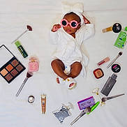 Aisha joined the competition — help win amazing prizes! baby, child, white_robe, pink_sunglasses, makeup_brush, makeup_palette, perfume, skincare, cosmetics, white_background, cute, fashion, beauty, accessories, lying_down, toddler, footwear, headband, relaxing, portrait