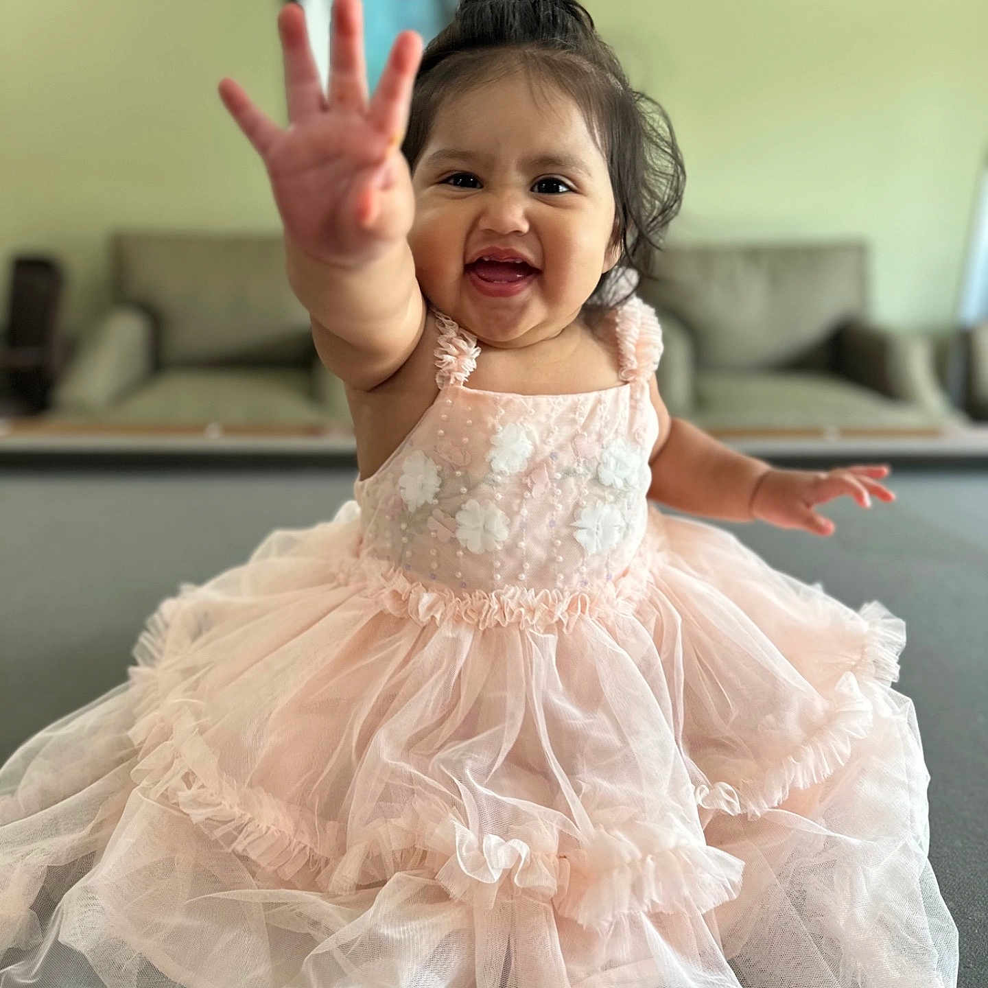 Adamaris is registered to the contest to win money with this photo: baby, child, couch, cute, face, furniture, happy, home, indoor, person, pink_dress, playful, portrait, reaching_hand, sitting, smiling, soft_lighting, toddler, wall_art, young_child