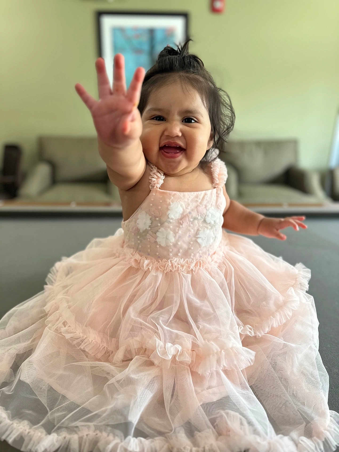 Adamaris is registered to the contest to win money with this photo: toddler, child, smiling, pink_dress, indoor, happy, reaching_hand, sitting, face, person, cute, portrait, furniture, couch, home, wall_art, soft_lighting, baby, young_child, playful