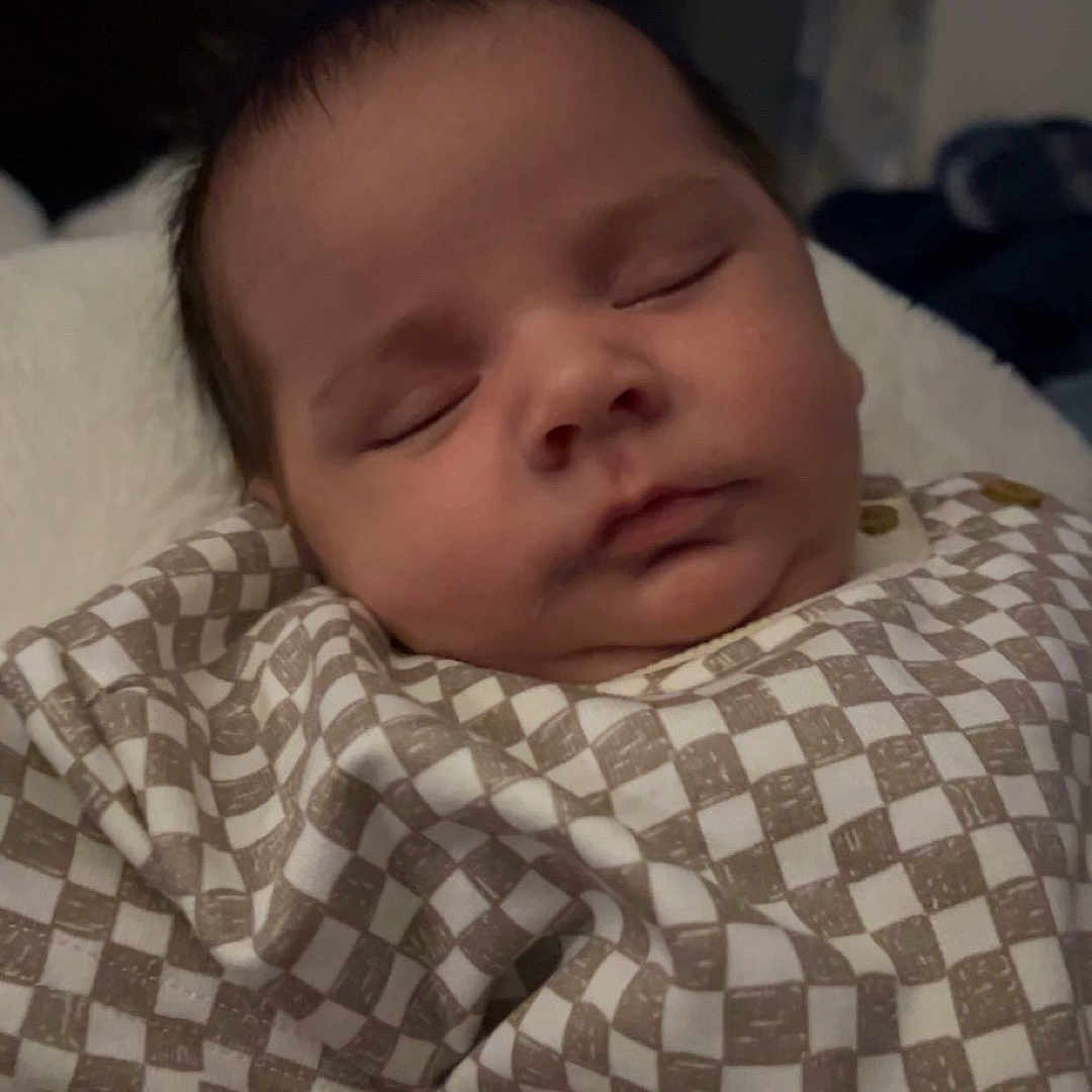 Roman joined the competition — help win amazing prizes! baby, sleeping, infant, checkered_clothing, soft_lighting, indoor, person, face, peaceful, child, portrait, newborn, relaxing, cute, young, skin, head, arm, home, rest