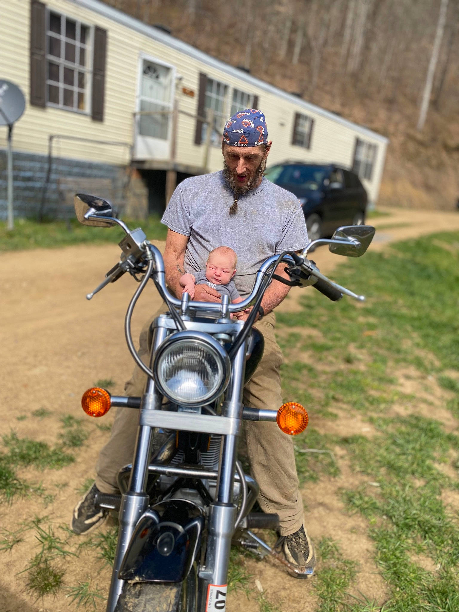 Gabriella is registered to the contest to win money with this photo: automotive_design, automotive_lighting, automotive_tire, automotive_wheel_system, bicycle_handlebar, chopper, fender, grass, headlamp, headwear, motor_vehicle, motorcycle, motorcycle_accessories, motorcycling, person, plant, recreation, tire, tree, vehicle