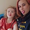 Skyler is registered to the contest to win money with this photo: child, adult, tongue_out, selfie, playful, smiling, casual_clothing, curly_hair, long_hair, indoor, portrait, fun, happy, light_skin, red_hair, seated, person, family, together, cute