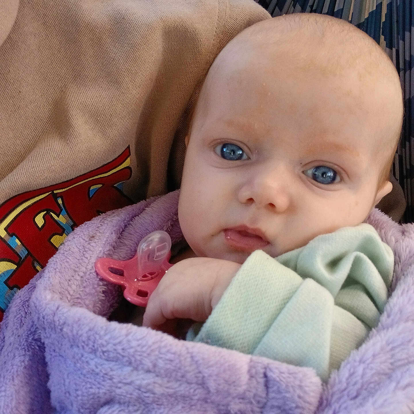 Jupiter joined the competition — help win amazing prizes! baby, infant, blue_eyes, blanket, pacifier, purple, clothing, face, closeup, portrait, person, cute, soft, warm, sitting, child, young, apparel, indoors, head