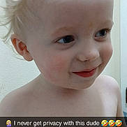 Jasper is registered to the contest to win money with this photo: toddler, child, smiling, shirtless, blonde_hair, curly_hair, face, eyes, skin, person, indoors, wall, door, expression, happy, cute, young_child, portrait, privacy, caption