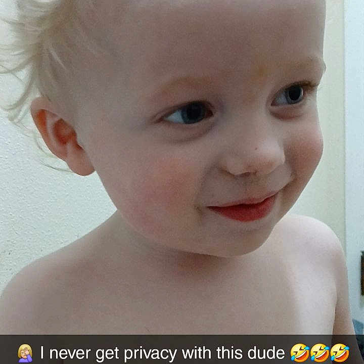 Jasper is registered to the contest to win money with this photo: toddler, child, smiling, shirtless, blonde_hair, curly_hair, face, eyes, skin, person, indoors, wall, door, expression, happy, cute, young_child, portrait, privacy, caption
