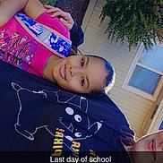 Katherine is registered to the contest to win money with this photo: child, smiling, backpack, outdoor, daylight, house, window, tree, grass, person, adult, casual_clothing, hoodie, sidewalk, portrait, happy, school, text_overlay, nature, sunlight