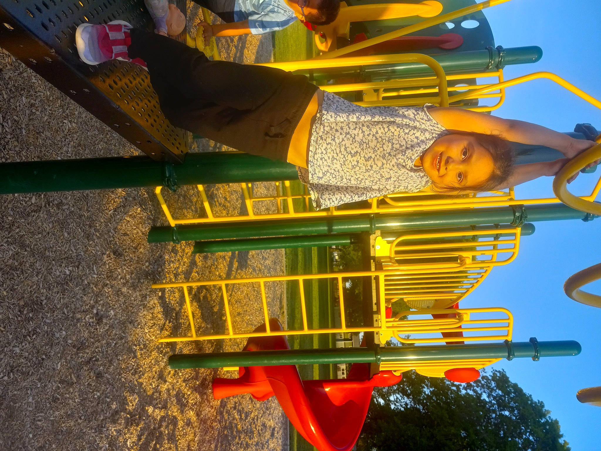 Katherine is registered to the contest to win money with this photo: amusement_ride, asphalt, automotive_exterior, city, fun, joy, leisure, light, person, recreation, road_surface, sky, smile, toddler, travel, tree, yellow