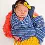 newborn, baby, sleeping, wrapped, blanket, headband, yellow_bow, blue_stripes, pink_blanket, yellow_blanket, cozy, soft, cute, portrait, infant, peaceful, tiny_feet, hands, studio, white_background