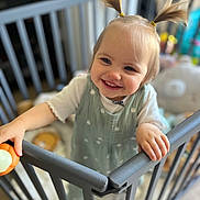Alice a rejoint le concours — aidez-le/la à gagner de superbes lots ! toddler, child, smiling, pigtails, baby_gate, nursery, toy, indoor, happy, person, clothing, face, hair, hand, furniture, room, play, infant, cute, childcare
