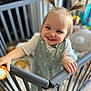 toddler, child, smiling, pigtails, baby_gate, nursery, toy, indoor, happy, person, clothing, face, hair, hand, furniture, room, play, infant, cute, childcare