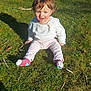 child, toddler, grass, outdoor, sunlight, smiling, happy, clothing, socks, sitting, person, nature, daylight, casual, cute, young, face, hair, shadow, playful