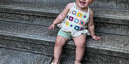 Malia joined the competition — help win amazing prizes! toddler, child, smiling, sitting, steps, concrete, outdoor, happy, footwear, sandals, shorts, crochet_top, bracelet, earrings, person, portrait, urban, daylight, cute, playful