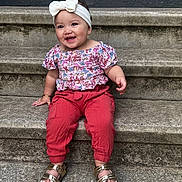 Malia joined the competition — help win amazing prizes! toddler, child, smiling, sitting, steps, concrete, headband, bow, floral_top, red_pants, gold_sandals, outdoor, happy, cute, portrait, person, fashion, accessories, jewelry, casual