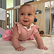 Marielaura is registered to the contest to win money with this photo: baby, infant, crawling, pink_clothing, smiling, happy, indoor, soft_surface, baby_gate, toy, child, person, cute, home, floor, playful, young_child, bright_eyes, closeup, portrait