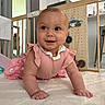 baby, infant, crawling, pink_clothing, smiling, happy, indoor, soft_surface, baby_gate, toy, child, person, cute, home, floor, playful, young_child, bright_eyes, closeup, portrait