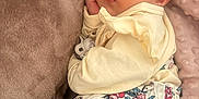 Aylé participe au concours pour gagner de l'argent avec cette photo : baby, sleeping, blanket, soft_texture, clothing, floral_pattern, face, infant, peaceful, resting, cute, pajamas, hand, closeup, indoors, comfort, child, young, cozy, nap