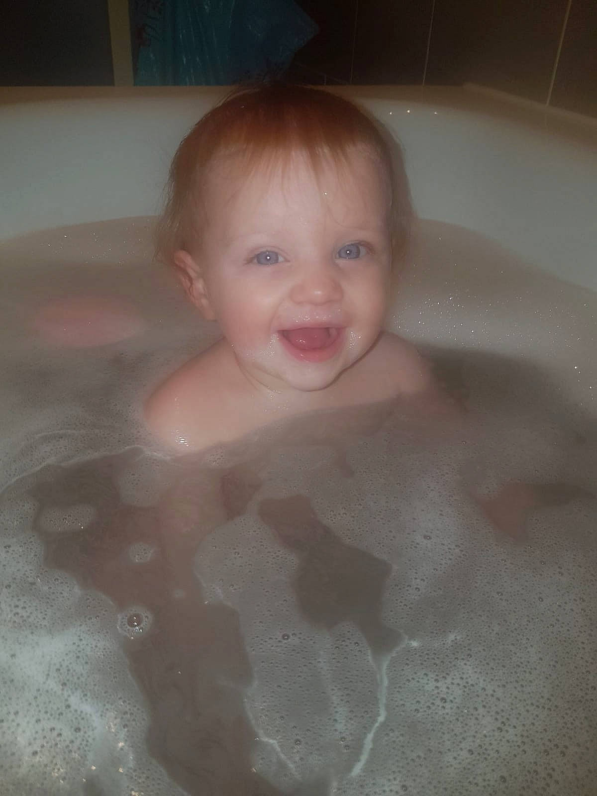 Daisy-mae is registered to the contest to win money with this photo: baby, bathing, bathroom, bathtub, child, composite_material, eye, fluid, foam, fun, happy, human_body, liquid, person, plumbing, plumbing_fixture, property, smile, thumb, toddler
