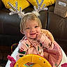 Koura is registered to the contest to win money with this photo: baby, child, infant, reindeer_antlers, pajamas, smiling, baby_walker, toy, furniture, couch, cushion, home_interior, holiday_theme, cute, blond_hair, indoor, childhood, playful, happy, person
